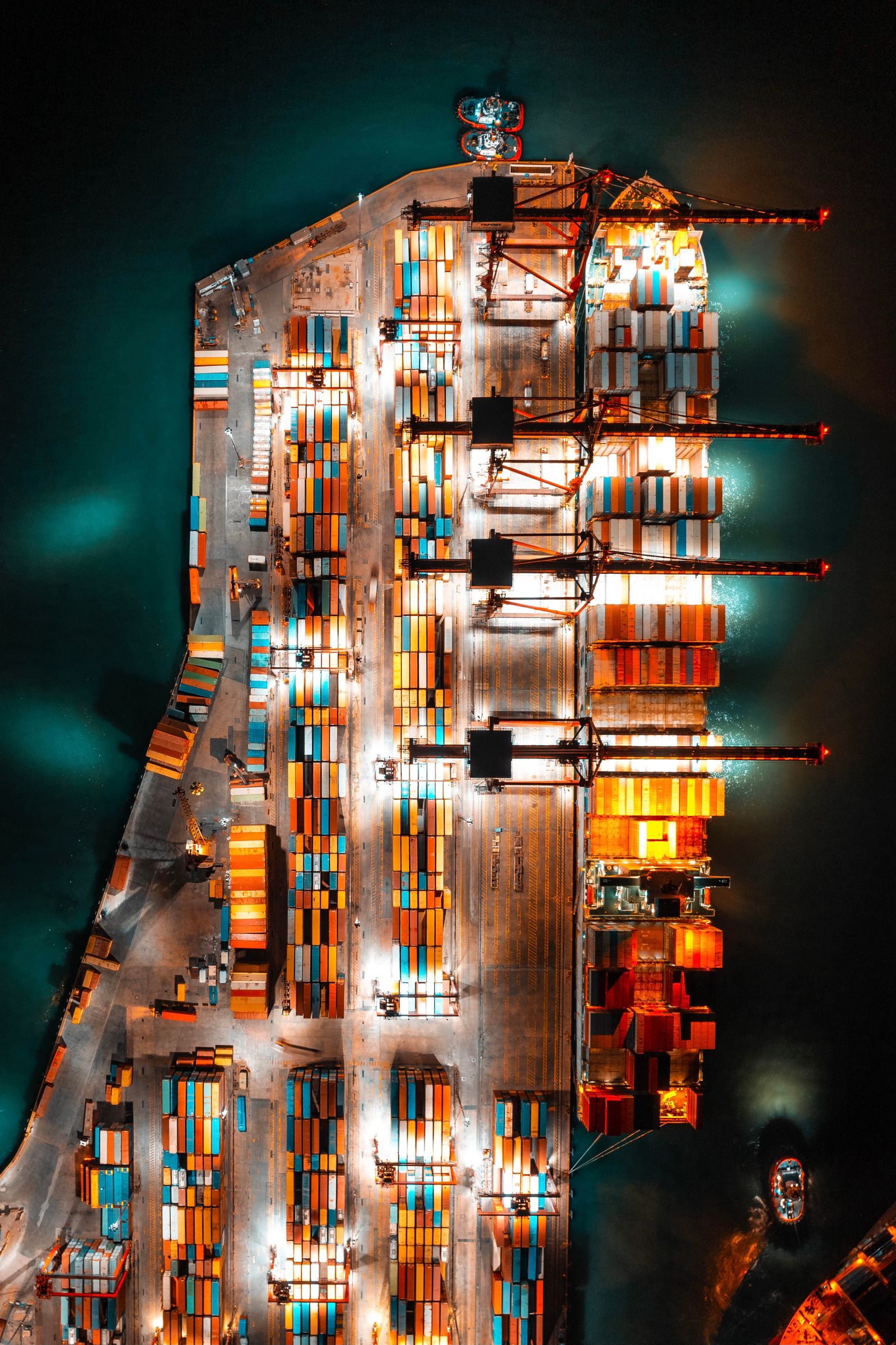 Aerial view of a container port at night — global trade and logistics